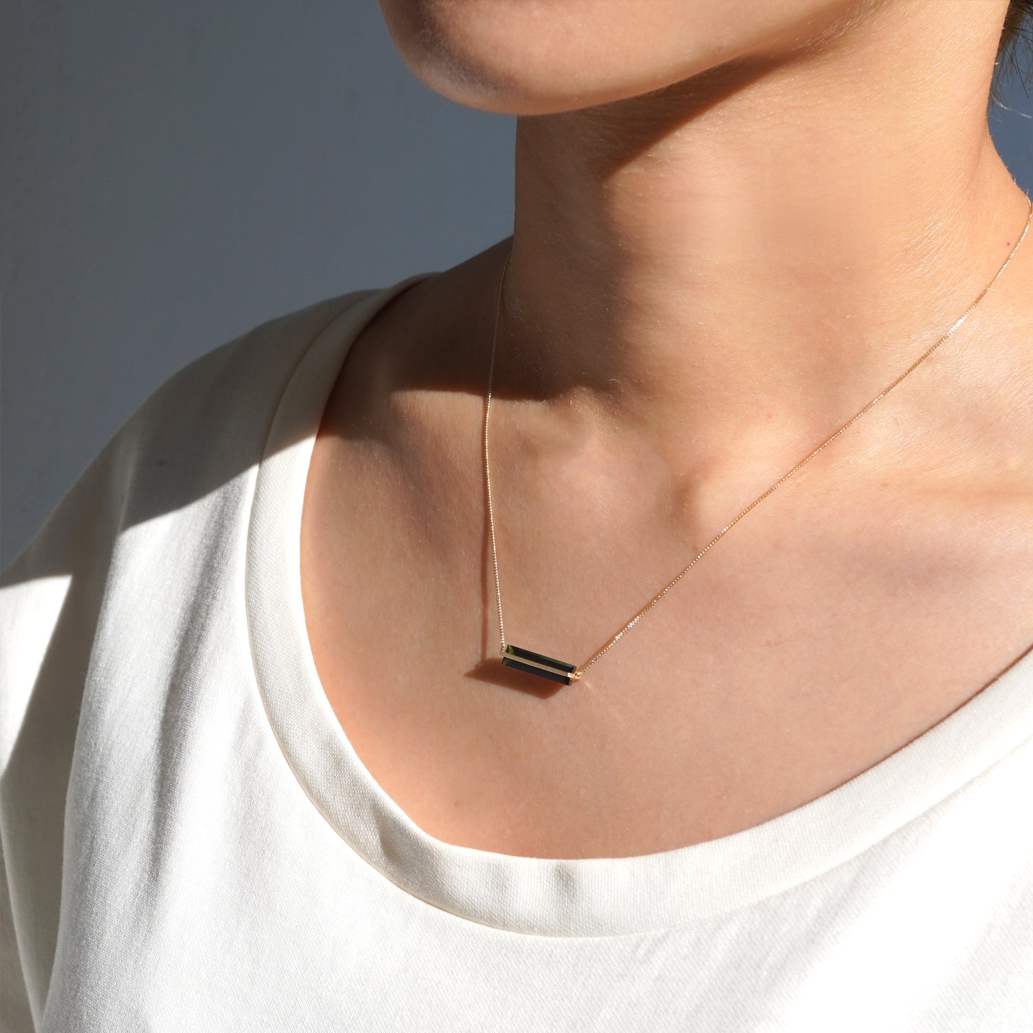 グリーントルマリンをセットしたK10イエローゴールドネックレスの向かって右から見た着用イメージ、首元での40cmの長さ感